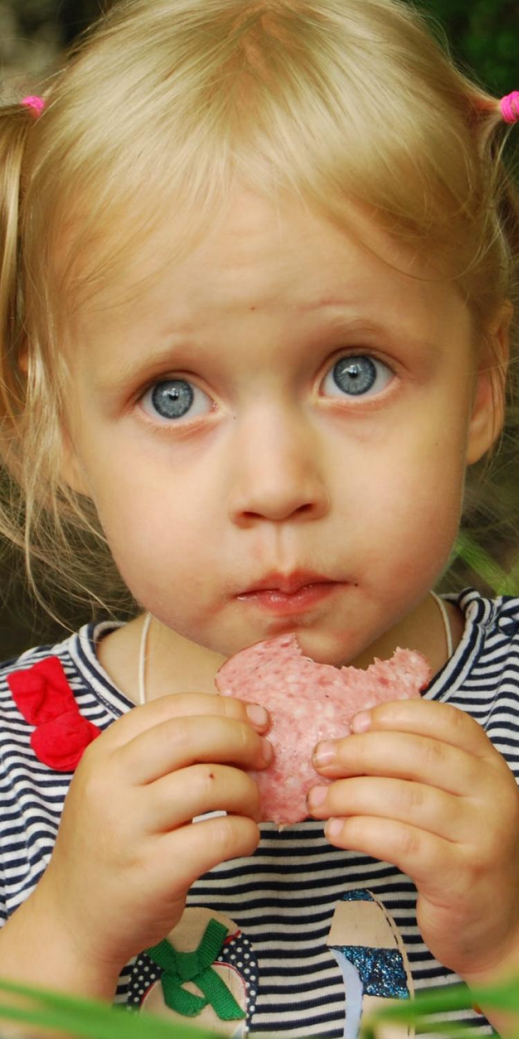 Girl eating salami