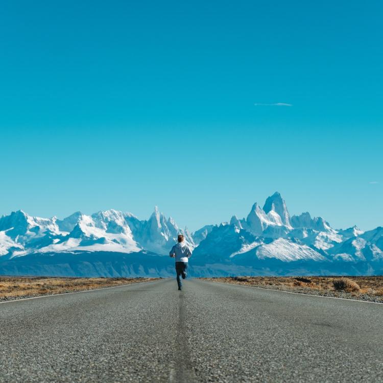 Man running towards mountains