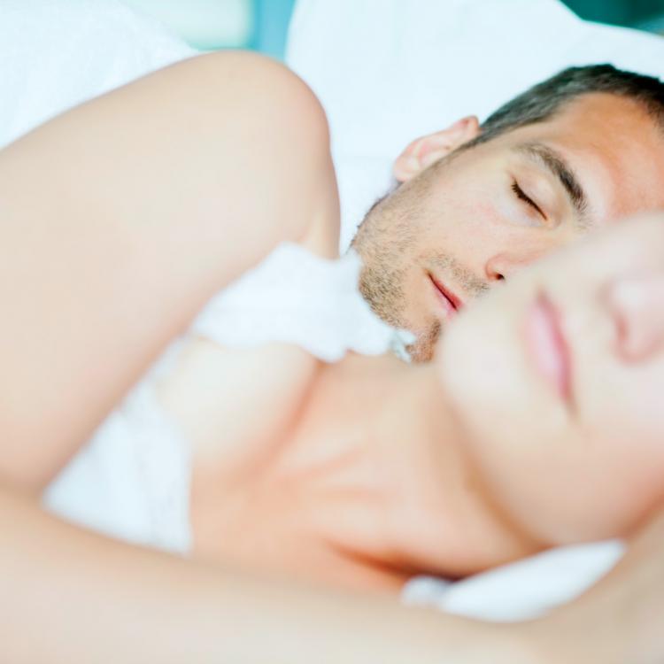 Man and woman sleeping in bed