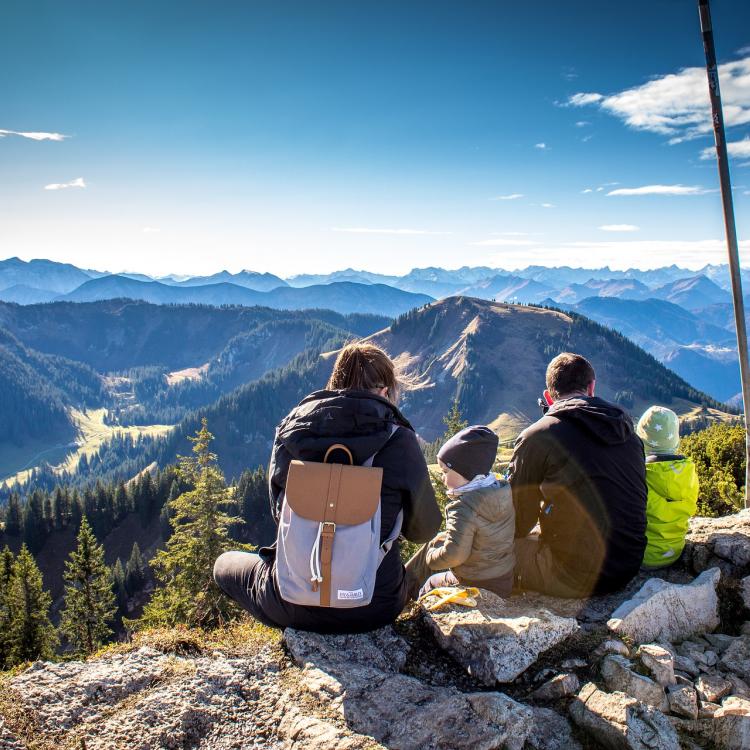 Kids and parents sitting on mountain