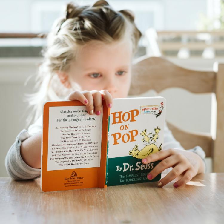 Girl reading Hop on Pop